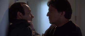 Movie still from “The Usual Suspects” (1995), directed by Bryan Singer – A man and a woman face to face in a room; Close Up shot, Over the shoulder angle