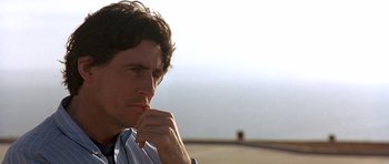 Movie still from “The Usual Suspects” (1995), directed by Bryan Singer – A person with his hand on his chin; Close Up shot, Low angle