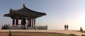 Movie still from “The Usual Suspects” (1995), directed by Bryan Singer – A pavilion with a bench in front of it; Extreme Wide shot, Low angle