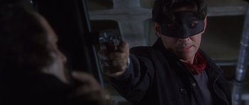 Movie still from “The Usual Suspects” (1995), directed by Bryan Singer – A man holding a cell phone in his hand; Close Up shot, Over the shoulder angle