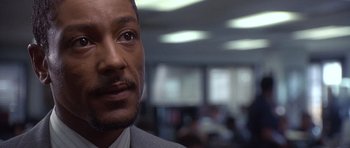 Movie still from “The Usual Suspects” (1995), directed by Bryan Singer – A person wearing a suit and tie; Close Up shot, Over the shoulder angle