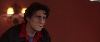 Movie still from “The Usual Suspects” (1995), directed by Bryan Singer – A person looking at the camera; Close Up shot, Over the shoulder angle