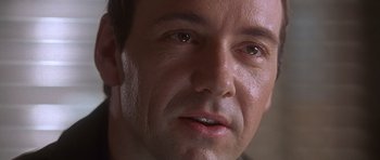 Movie still from “The Usual Suspects” (1995), directed by Bryan Singer – A man's face with a lot of wrinkles on his face; Close Up shot, Over the shoulder angle