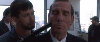 Movie still from “The Usual Suspects” (1995), directed by Bryan Singer – A man with his eyes closed and a man with his mouth open; Close Up shot, Over the shoulder angle
