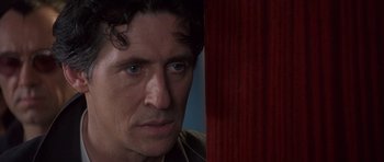 Movie still from “The Usual Suspects” (1995), directed by Bryan Singer – A person looking at the camera; Close Up shot, Over the shoulder angle