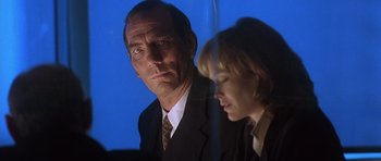 Movie still from “The Usual Suspects” (1995), directed by Bryan Singer – A man and a woman are looking at the camera; Close Up shot, Low angle