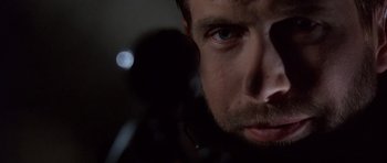 Movie still from “The Usual Suspects” (1995), directed by Bryan Singer – A man's face in a dimly - lit room; Extreme Close Up shot, Low angle