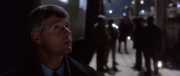 Movie still from “The Usual Suspects” (1995), directed by Bryan Singer – A man in a suit and tie looking to his left; Close Up shot, Low angle