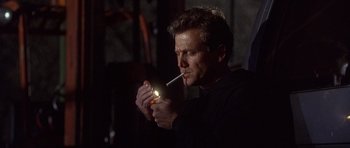 Movie still from “The Usual Suspects” (1995), directed by Bryan Singer – A man is lighting a cigarette in the dark; Close Up shot, Low angle