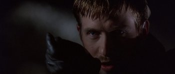 Movie still from “The Usual Suspects” (1995), directed by Bryan Singer – A man's face in the dark; Close Up shot, Low angle
