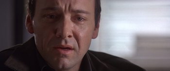 Movie still from “The Usual Suspects” (1995), directed by Bryan Singer – A man's face as he stares into the camera; Close Up shot, Low angle