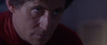 Movie still from “The Usual Suspects” (1995), directed by Bryan Singer – A man's face in a dark room; Close Up shot, Low angle