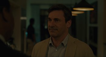 Movie still from “Confess, Fletch” (2022), directed by Greg Mottola – A person wearing a jacket; Close Up shot, Over the shoulder angle