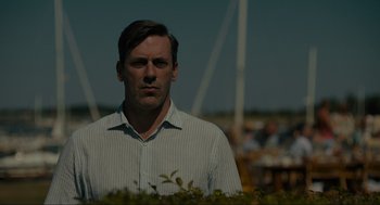 Movie still from “Confess, Fletch” (2022), directed by Greg Mottola – A person wearing a dress shirt; Close Up shot, Low angle