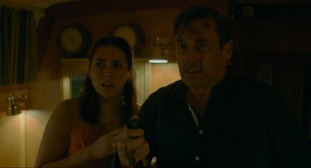 Movie still from “Confess, Fletch” (2022), directed by Greg Mottola – A man and a woman are looking at the camera; Close Up shot, Low angle