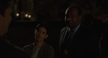 Movie still from “Confess, Fletch” (2022), directed by Greg Mottola – A man and a woman standing next to each other in the dark; Close Up shot, Over the shoulder angle