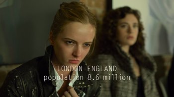 Movie still from “Contagion” (2011), directed by Steven Soderbergh – A woman is holding a cell phone in front of another woman; Close Up shot, Over the shoulder angle