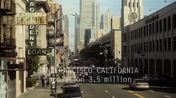 Movie still from “Contagion” (2011), directed by Steven Soderbergh – A city street filled with lots of traffic and tall buildings; Extreme Wide shot, High angle