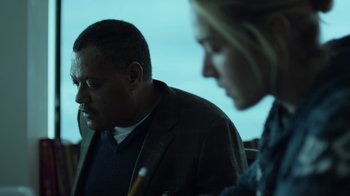 Movie still from “Contagion” (2011), directed by Steven Soderbergh – A man and a woman sitting next to each other; Close Up shot, Low angle