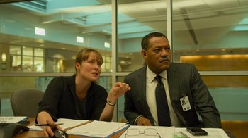 Movie still from “Contagion” (2011), directed by Steven Soderbergh – A man and a woman are sitting at a table; Medium shot, Over the shoulder angle