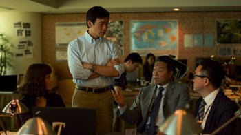Movie still from “Contagion” (2011), directed by Steven Soderbergh – Two men in a room with a map on the wall behind them; Medium shot, Over the shoulder angle