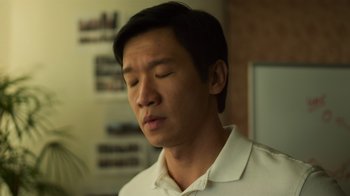 Movie still from “Contagion” (2011), directed by Steven Soderbergh – A man with his eyes closed in a room; Close Up shot, Over the shoulder angle