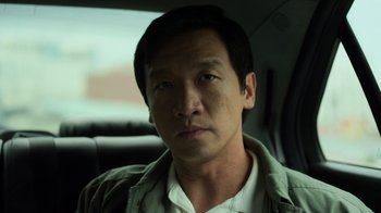 Movie still from “Contagion” (2011), directed by Steven Soderbergh – A person sitting in a car; Close Up shot, Low angle
