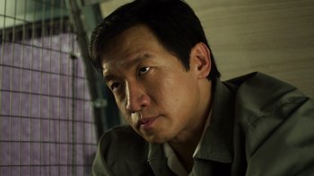 Movie still from “Contagion” (2011), directed by Steven Soderbergh – A person wearing a jacket; Close Up shot, Low angle