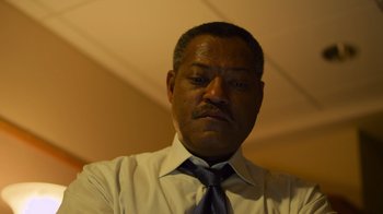 Movie still from “Contagion” (2011), directed by Steven Soderbergh – A person wearing a shirt and a tie; Close Up shot, Low angle
