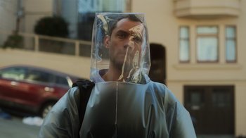 Movie still from “Contagion” (2011), directed by Steven Soderbergh – A man wearing a plastic bag over his head; Close Up shot, Over the shoulder angle