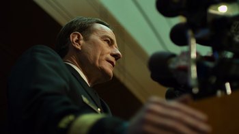 Movie still from “Contagion” (2011), directed by Steven Soderbergh – A person talking on a microphone; Close Up shot, Low angle