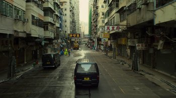 Movie still from “Contagion” (2011), directed by Steven Soderbergh – A car driving down a street in a city; Extreme Wide shot, High angle