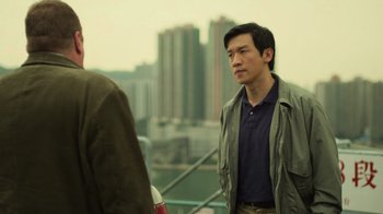 Movie still from “Contagion” (2011), directed by Steven Soderbergh – A man standing next to another man on a bridge; Medium shot, Over the shoulder angle