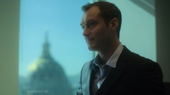 Movie still from “Contagion” (2011), directed by Steven Soderbergh – A person wearing a suit and tie; Close Up shot, Low angle