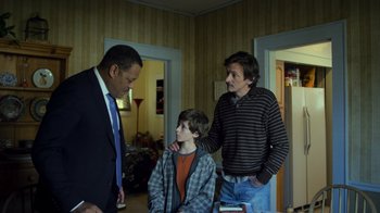 Movie still from “Contagion” (2011), directed by Steven Soderbergh – Two men and a young boy in a room; Medium shot, Over the shoulder angle