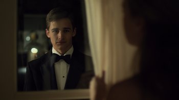Movie still from “Contagion” (2011), directed by Steven Soderbergh – A man in a tuxedo looking in a mirror; Close Up shot, Over the shoulder angle