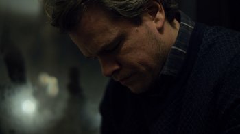 Movie still from “Contagion” (2011), directed by Steven Soderbergh – A person looking down at his face; Close Up shot, Low angle