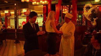 Movie still from “Contagion” (2011), directed by Steven Soderbergh – Two men and a woman standing in front of a bar; Medium shot, Over the shoulder angle