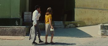 Movie still from “Contempt” (1963), directed by Jean-Luc Godard – A man and a woman walking down a street; Wide shot, Low angle