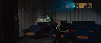 Movie still from “Contempt” (1963), directed by Jean-Luc Godard – A man and a woman are sitting in chairs in a room; Wide shot, Low angle