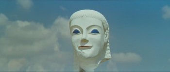 Movie still from “Contempt” (1963), directed by Jean-Luc Godard – A statue of a woman's face with blue eyes; Close Up shot, Low angle