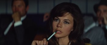 Movie still from “Contempt” (1963), directed by Jean-Luc Godard – A beautiful woman holding a tooth brush in her mouth; Close Up shot, High angle
