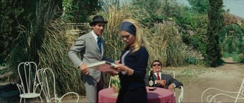 Movie still from “Contempt” (1963), directed by Jean-Luc Godard – A man and a woman are holding a frisbee; Medium shot, Over the shoulder angle