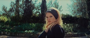 Movie still from “Contempt” (1963), directed by Jean-Luc Godard – A woman with blonde hair wearing a black headband; Close Up shot, Low angle