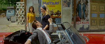 Movie still from “Contempt” (1963), directed by Jean-Luc Godard – A man and a woman in front of a piano; Medium shot, Over the shoulder angle