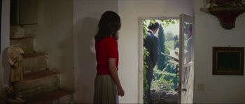 Movie still from “Contempt” (1963), directed by Jean-Luc Godard – A woman standing in front of a man in front of a window; Medium shot, Low angle