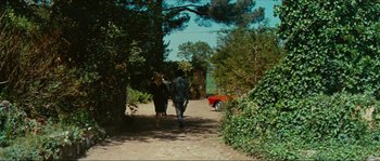 Movie still from “Contempt” (1963), directed by Jean-Luc Godard – Two people walking down a dirt road with a horse; Extreme Wide shot, High angle