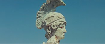 Movie still from “Contempt” (1963), directed by Jean-Luc Godard – A statue of a person wearing a helmet; Close Up shot, Low angle