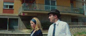Movie still from “Contempt” (1963), directed by Jean-Luc Godard – A man and a woman walking down a street; Medium shot, Low angle