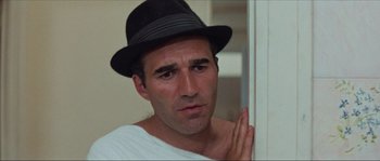 Movie still from “Contempt” (1963), directed by Jean-Luc Godard – A person wearing a hat; Close Up shot, Low angle